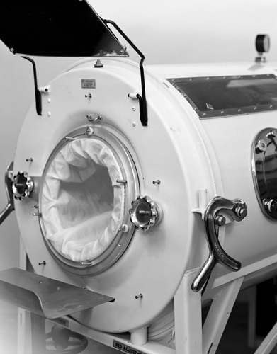 A metal iron lung. A metal tube approximately 6 feet long that a patient would lie in, head and feet emerging from each end.