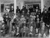 Male residents gather on the front steps of their dormitory