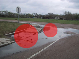 Sidewalk covered in water. Needs better drainage.